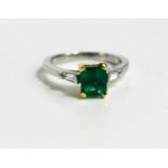 A platinum and 18ct mounted emerald and diamond ring, size K, 4.3g.
