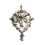 A Victorian 19th century diamond set pendant, in the form of a bow bordered by a leafy floral