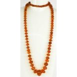 A Victorian amber necklace with 9ct gold clasp, composed of faceted graduated beads, 69g.