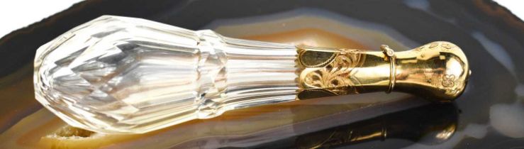 A fine cut glass and gold plated scent bottle, the bulbous cover opens to reveal a silver mounted