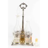 A 19th century triform silver plated decanter holder, with three cut glass decanters etched with
