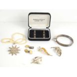 A group of silver jewellery to include two silver leaf form brooches, a silver bracelet with