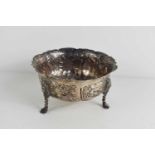 A Victorian silver bowl decorated with birds and animals in high relief with lion heads, cabriole