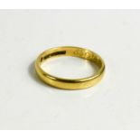 An 18ct yellow gold wedding band, size P, 3g