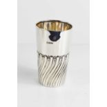 A silver beaker, Chester 1903, decorated with fluted and reeded decoration to the mid section,