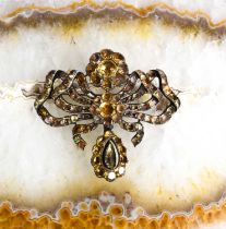 A Georgian silver and yellow gem set metamorphic brooch pendant, in the form of a bow with flower