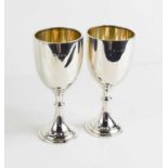 A pair of silver goblets, Birmingham 1935, with residual gilded interiors, one bearing