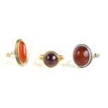 A 9ct gold [tested as] and garnet cabochon ring, size O/N, 3.9g together with two silver and