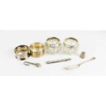 A group of silver to include thimble, two napkin rings, nail file holder, and slice, 2.03toz,