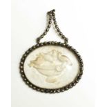 A late Georgian marcasite and pressed glass pendant, depicting birds watering at an urn, with an