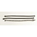 A pair of white and black stone tennis bracelets, likely cubic zircona, Italian silver, each 19cm