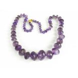 A Victorian amethyst beaded necklace with 9ct gold clasp, composed of faceted graduated beads.