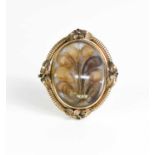 A Victorian pinchbeck mourning brooch on stand, of oval form, inset with lockets of hair woven