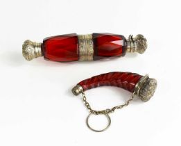 Two Victorian red glass scent bottles, one in the form of a cornucopia.