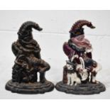 Two cast iron door stops in the form of Mr Punch, one painted with detail, 30cm high.