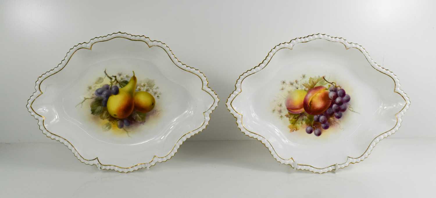 A pair of Royal Worcester oblong dishes, by Roberts, puce mark for 1920s, painted with fruit;