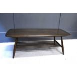 An Ercol dark elm coffee table with magazine rack, 105cm wide