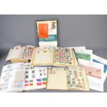 A group of stamp albums containing GB and worldwide stamps together with four coin covers.