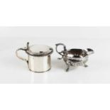 An early George III silver cream jug, with acanthus scroll handle, the flared cauldron body,