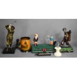 A group of golfing related memorabilia to include a painted metal money box, two Art Deco style