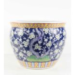 A 20th century Chinese jardiniere or fish bowl, decorated with prunus blossom on a cobalt blue