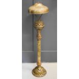 A 19th century brass Indonesian lamp, possibly converted from a lantern, embossed with decoration,