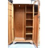 A vintage 1950s wardrobe with part shelved interior, lime washed finish and two panel doors,