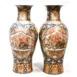 A pair of Japanese baluster form vases, with dark blue ground, painted with panels of flowers,