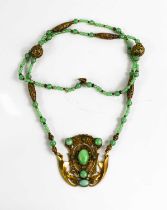 An Art Noveau style jade and gold coloured metal pendant necklace.