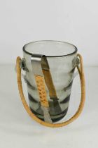 A Holmgaard smoky glass mid century ice bucket, with rattan handle and matching brushed steel pair