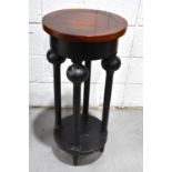 A modern ebonised occasional table with boldly turned legs and lower platform, 87cm high together