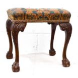 A late 19th century mahogany stool in the George III style, raised on cabriole legs carved with