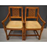 A pair of Rabbit Man adzed oak carver chairs, with lattice backs, with downswept arms and leather