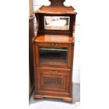 A 19th century mahogany music cabinet with mirrored back, rasied on ogee bracket feet.