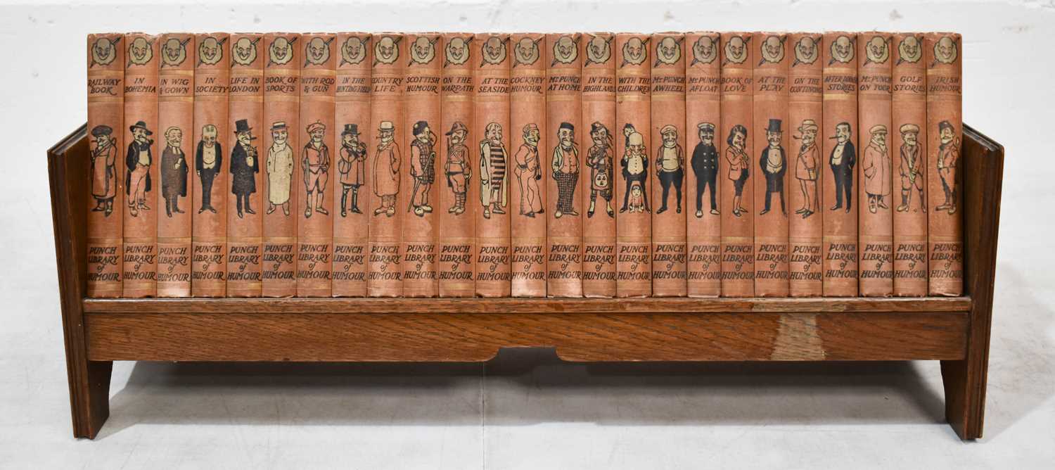 A set of Punch Library of Humour, 25 volumes, circa 1920, with pictorial cloth bindings, with oak