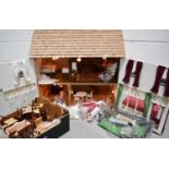 A six bedroom doll's house, complete with garden, electrics, dolls, furniture and accessories and