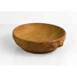 A Robert Thompson 'Mouseman' oak nut bowl, with carved signature mouse to the edge, 16cm diameter.