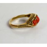A 9ct gold and coral three stone ring.