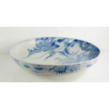 A large Japanese blue and white charger, depicting a landscape scene, 46cm diameter.
