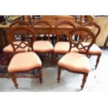 A set of six mahogany Victorian style balloon back chairs with upholstered seats.