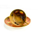 A Royal Worcester cup and saucer, the cup painted with fruit to the interior with peaches and
