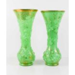 A pair of Baccarat green opal glass vases with raised moulded grape & vine decoration, with gilded