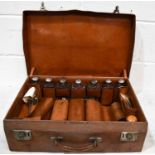A 19th century gentleman's travelling suitcase, containing eight silver bottles, London 1907, in