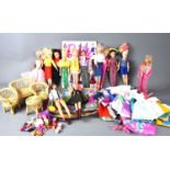 A group of vintage Sindy, Barbie and Ken dolls together with a quantity of clothing and a boxed