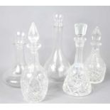 Five glass and crystal glass decanters to include cut glass examples.