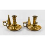 A pair of antique brass chamber sticks with the original snuffers.