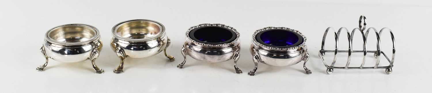 Two pairs of George III silver salts, both of cauldron form, each raised on three stepped hoofed