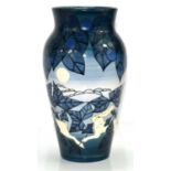 A Dennis China Works pottery vase by Sally Tuffin, blue ground and decorated with hares in the