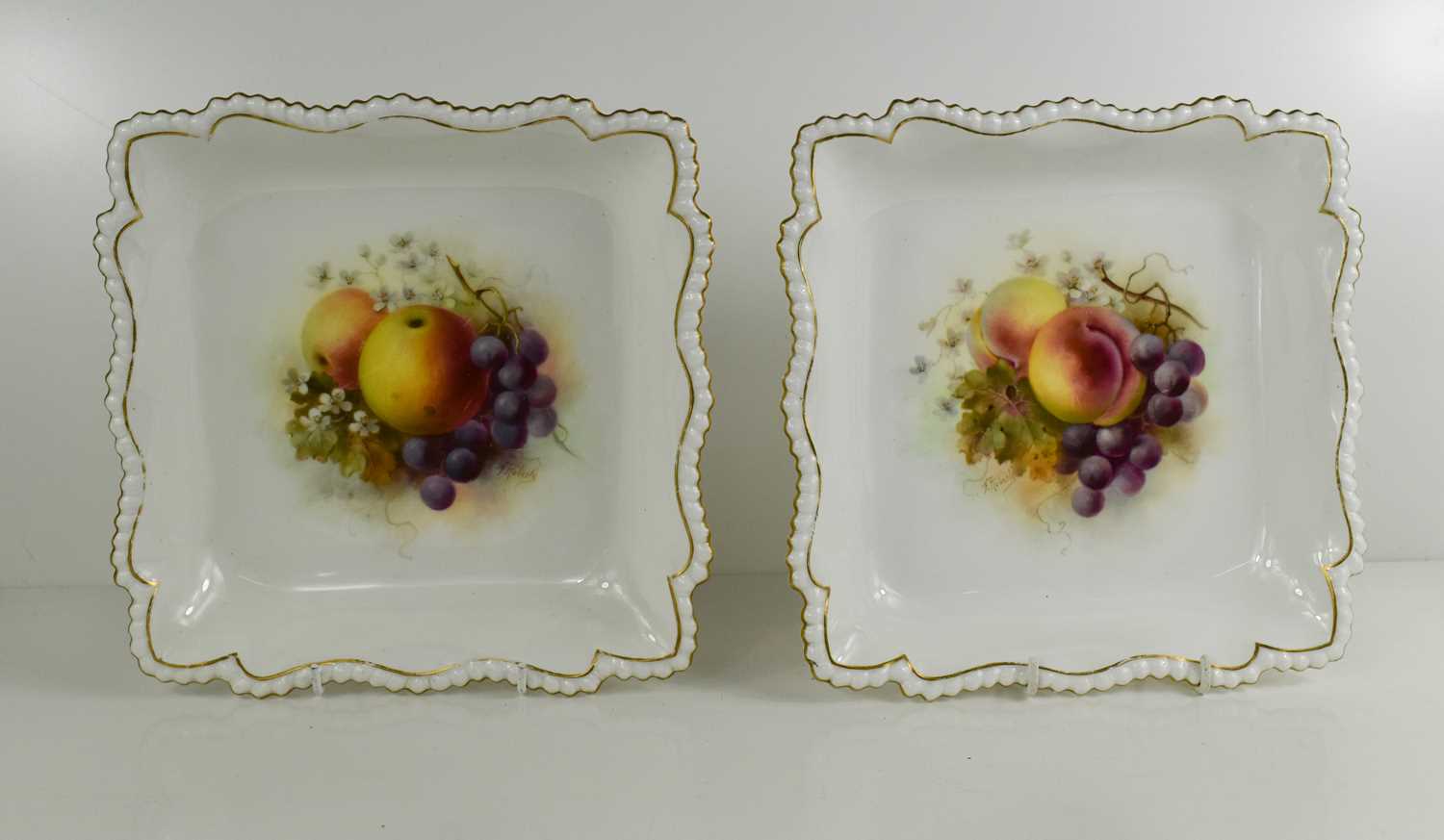 A pair of Royal Worcester square dishes, painted with fruit to the centre, by Roberts, with