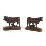 A pair of finely carved Black Forest cow and bull figures, signed H. Schild, Schnitzlerschule Brienz